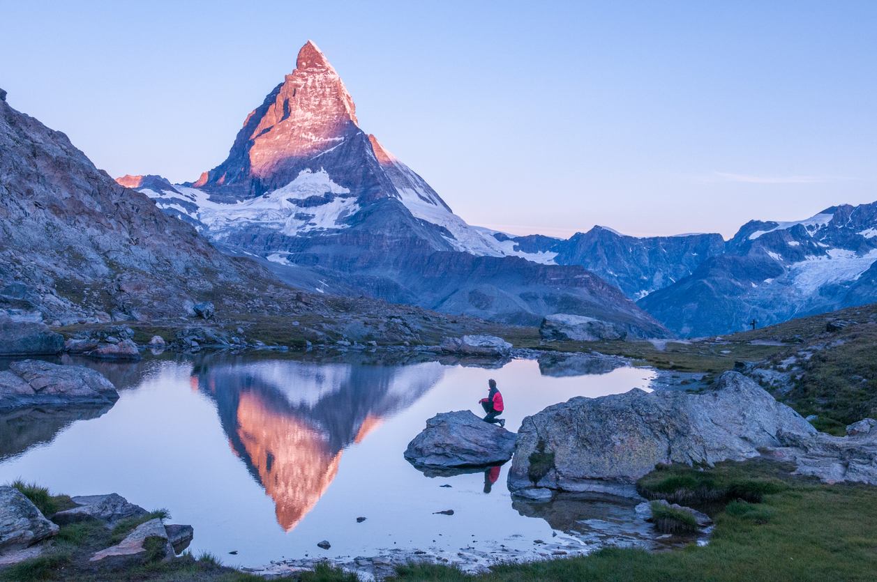 The Matterhorn at dawn, reflected in a lake below Zermatt